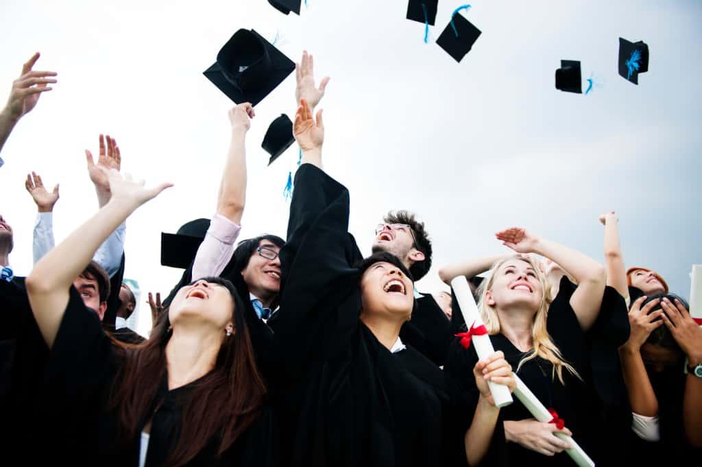 Graduates throwing their caps into the air in celebration